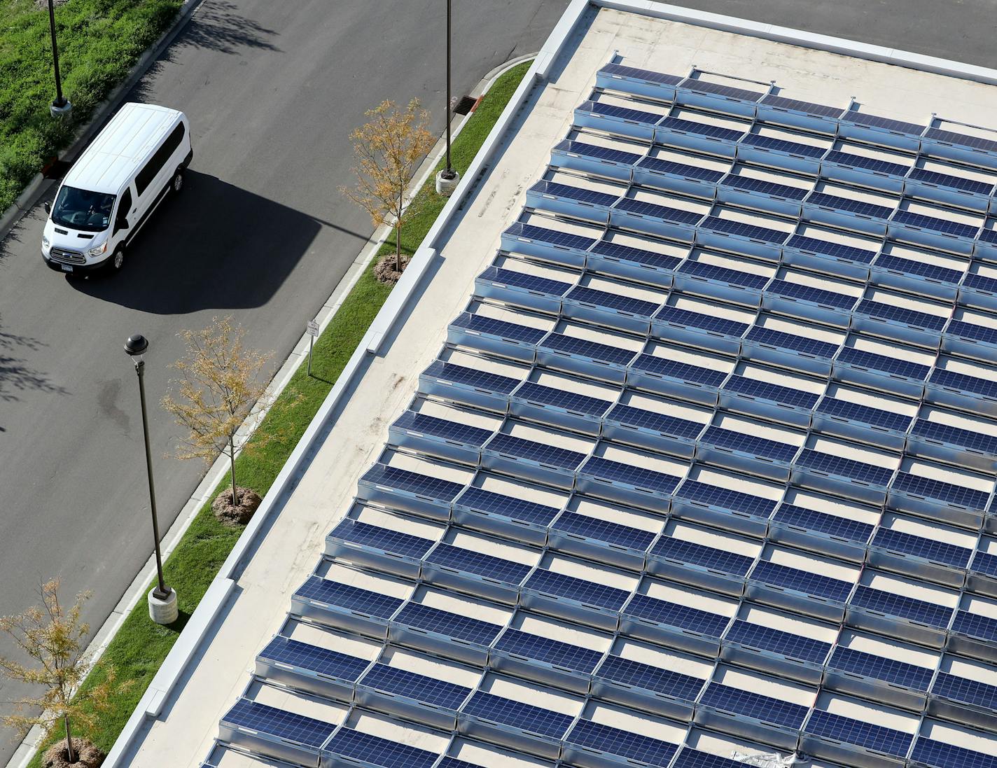 Some of the 450 solar panels that make up a solar array atop the parking garage behind the CityVue Apartments, formerly owned by Blue Cross and Blue Shield of Minnesota, are visible from the 10th floor Wednesday, Aug. 31, 2016, in Eagan, MN.](DAVID JOLES/STARTRIBUNE)djoles@startribune Don Jacobson's weekly real estate column is about developers that are incorporating solar power into their apartment buildings.