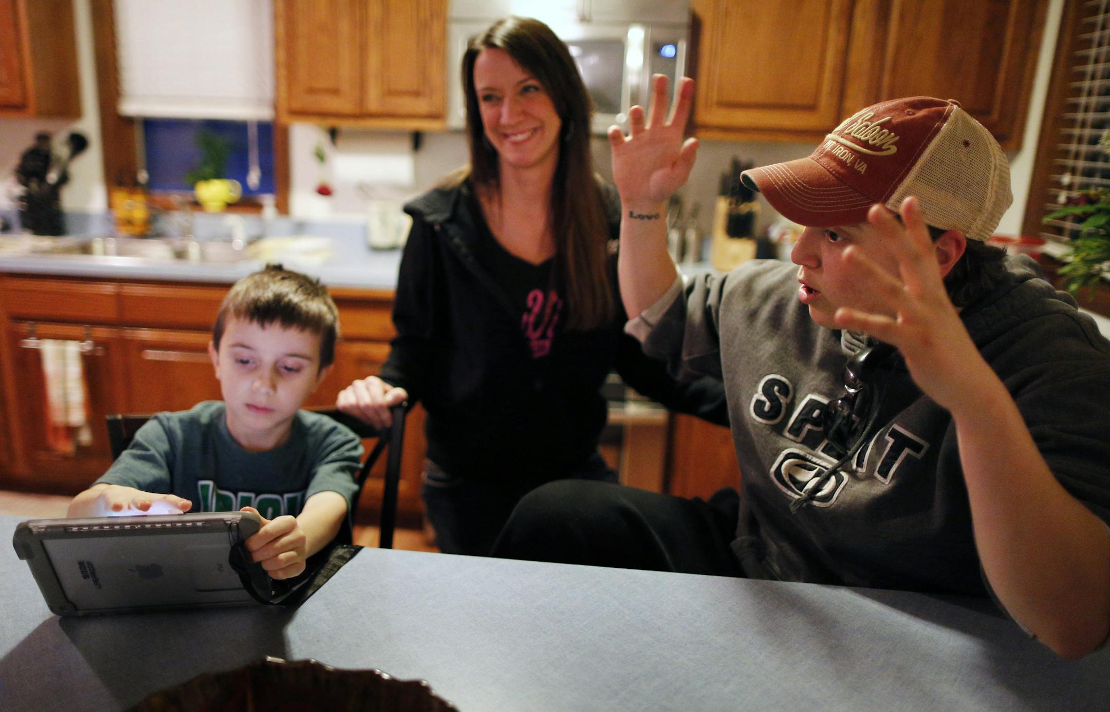 Katie DeBlack (right) is a truck driver at Minntac expecting to be laid off in June. Here she works with her son Riley Zylka, 7, on his homework at the kitchen table. Partner Jenny Zylka (center) who works at the Saw Mill restaurant in Virginia and fears that a shut down will affect her job at the restaurant as well. United States Steel Corp. plans to temporarily idle part of its Minntac plant in Mountain Iron, Minn. on June 1. ] Chisholm, MN - 4/6/2015 ORG XMIT: MIN1504071942332931