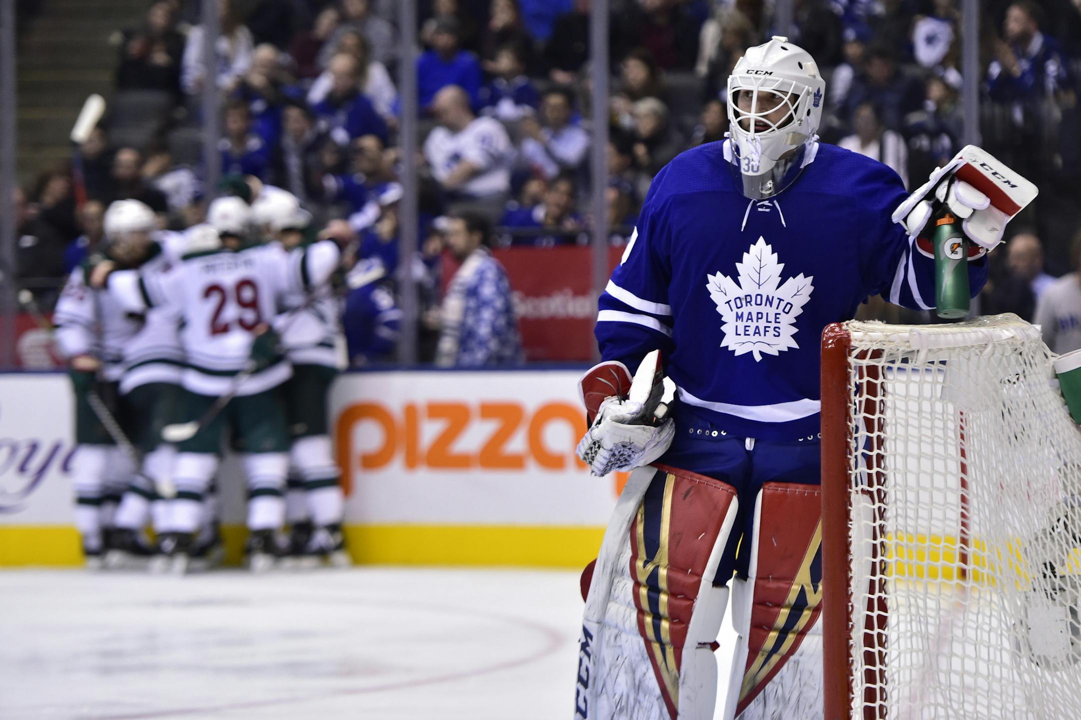 Toronto Maple Leafs goaltender Michael Hutchinson (30) looks on as Minnesota Wild players celebrate a goal by Zach Parise (11) during the third period of an NHL hockey game, Thursday, Jan. 3, 2019 in Toronto. (Frank Gunn/The Canadian Press via AP)