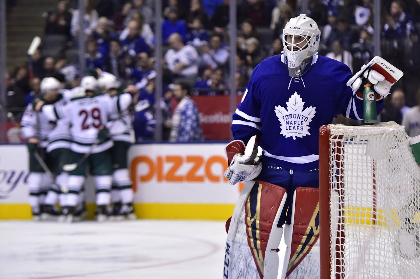 Toronto Maple Leafs goaltender Michael Hutchinson (30) looks on as Minnesota Wild players celebrate a goal by Zach Parise (11) during the third period of an NHL hockey game, Thursday, Jan. 3, 2019 in Toronto. (Frank Gunn/The Canadian Press via AP)