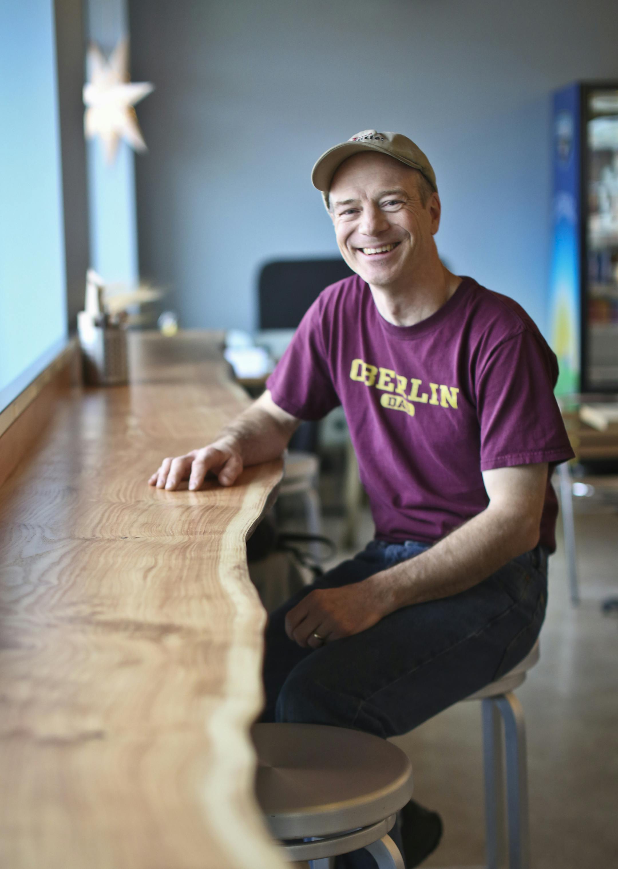 Owner (and dishwasher) Daniel Swenson-Klatt sat at a 15' foot solid wood counter that came from a honey locust tree in Powderhorn Park at Butter Bakery Cafe at the new location on Nicollet Avenue in Minneapolis, Minn. on Wednesday, February 13, 2013. ] (RENEE JONES SCHNEIDER reneejones@startribune.com)
