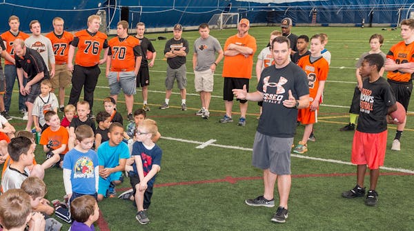 Ryan Stockhaus addressed youth football players at a clinic one day after being hired as the new Osseo head football coach