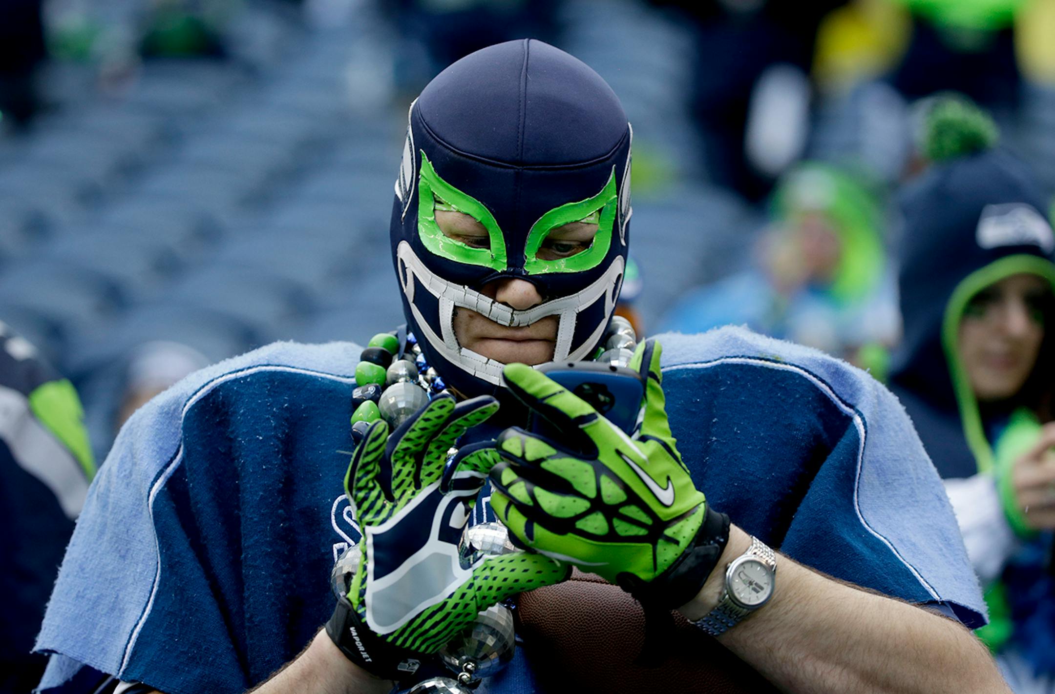 A Seattle Seahawks fan looks at his phone in Seattle.