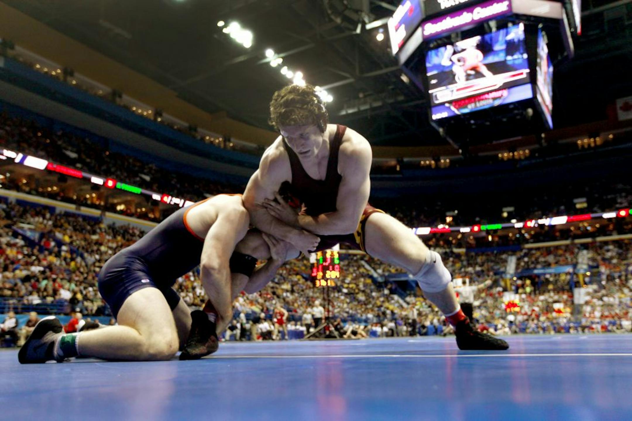 Virginia's Jonathan Fausey, left, and Minnesota's Kevin Steinhaus grapple during their 184-pound NCAA second-round match last spring.