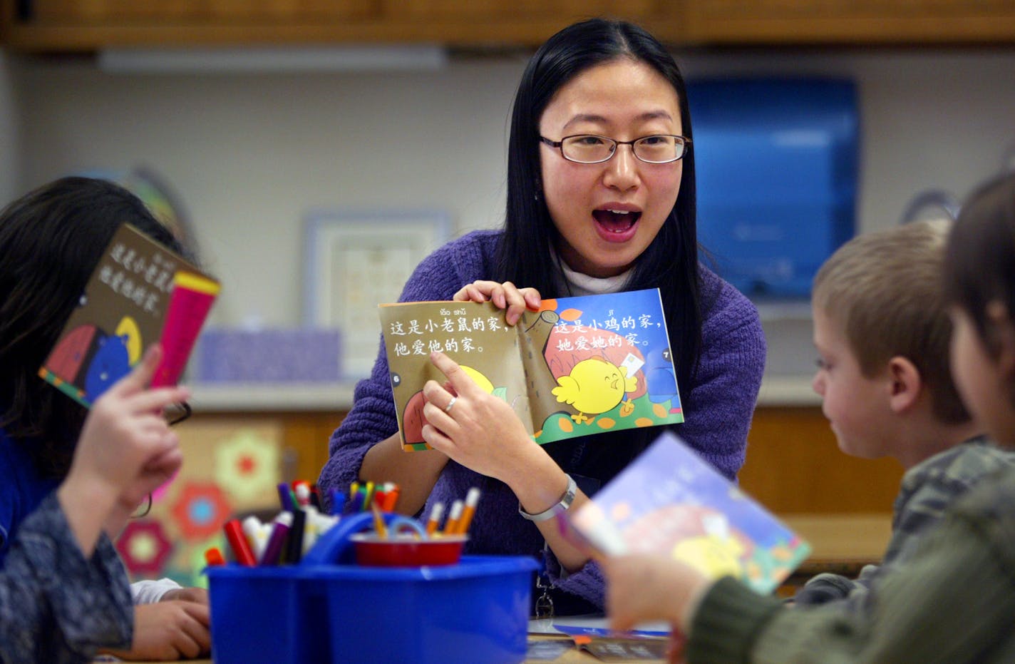 Kindergarten teacher Jie Gao read to her students in Mandarin. "The parents are very brave," she said. "They realize we are becoming a global village."