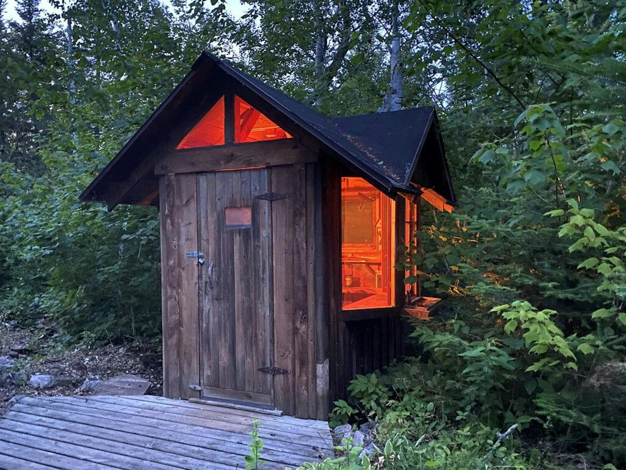 The outhouse, which has electricity and a bay window.