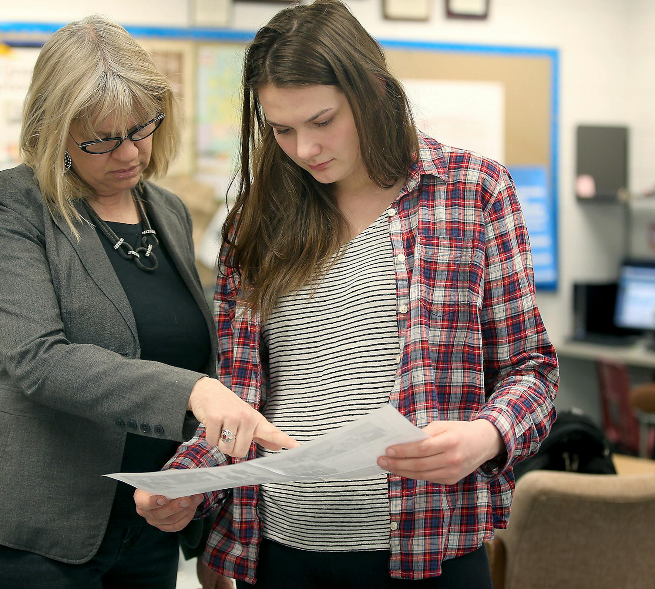 Stillwater High School teacher and yearbook supervisor, Laurie Hansen worked with student Ahnika Kroll put the pages of their yearbook together, Friday, April 10, 2015 in Stillwater, MN. ] (ELIZABETH FLORES/STAR TRIBUNE) ELIZABETH FLORES • eflores@startribune.com