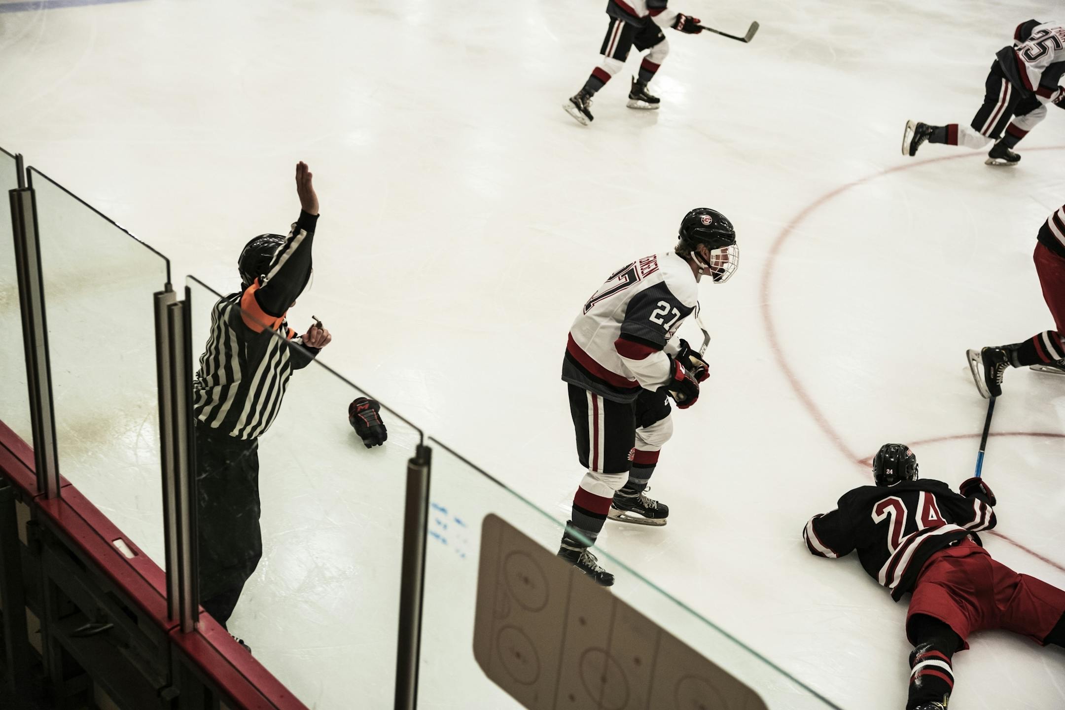 C.J. Beaurline calls a tripping penalty. He has over 20 years of experience as an official. He also works Gophers' hockey games on the weekend. On the left is linmesman David Berthiaume and on the far right is Joe Harris.