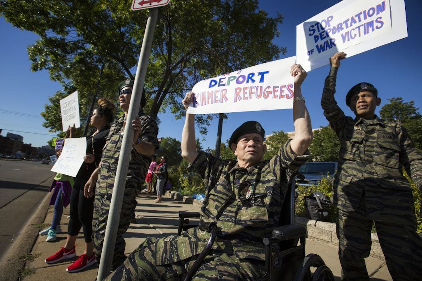 Sameth Kul, center, and Serey Sok, right, rally against the deportations of Cambodians in the Twin Cities.