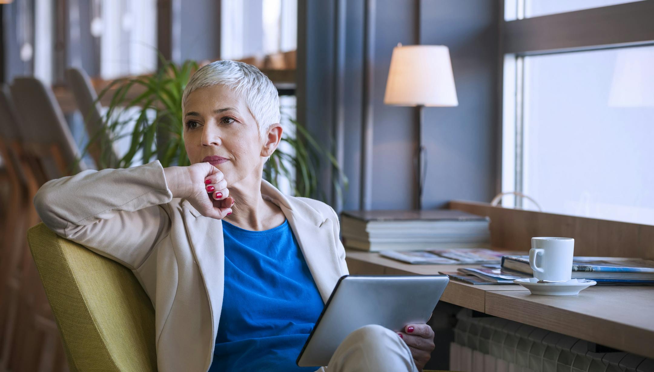 Senior business woman working on digital tablet at restaurant. istock