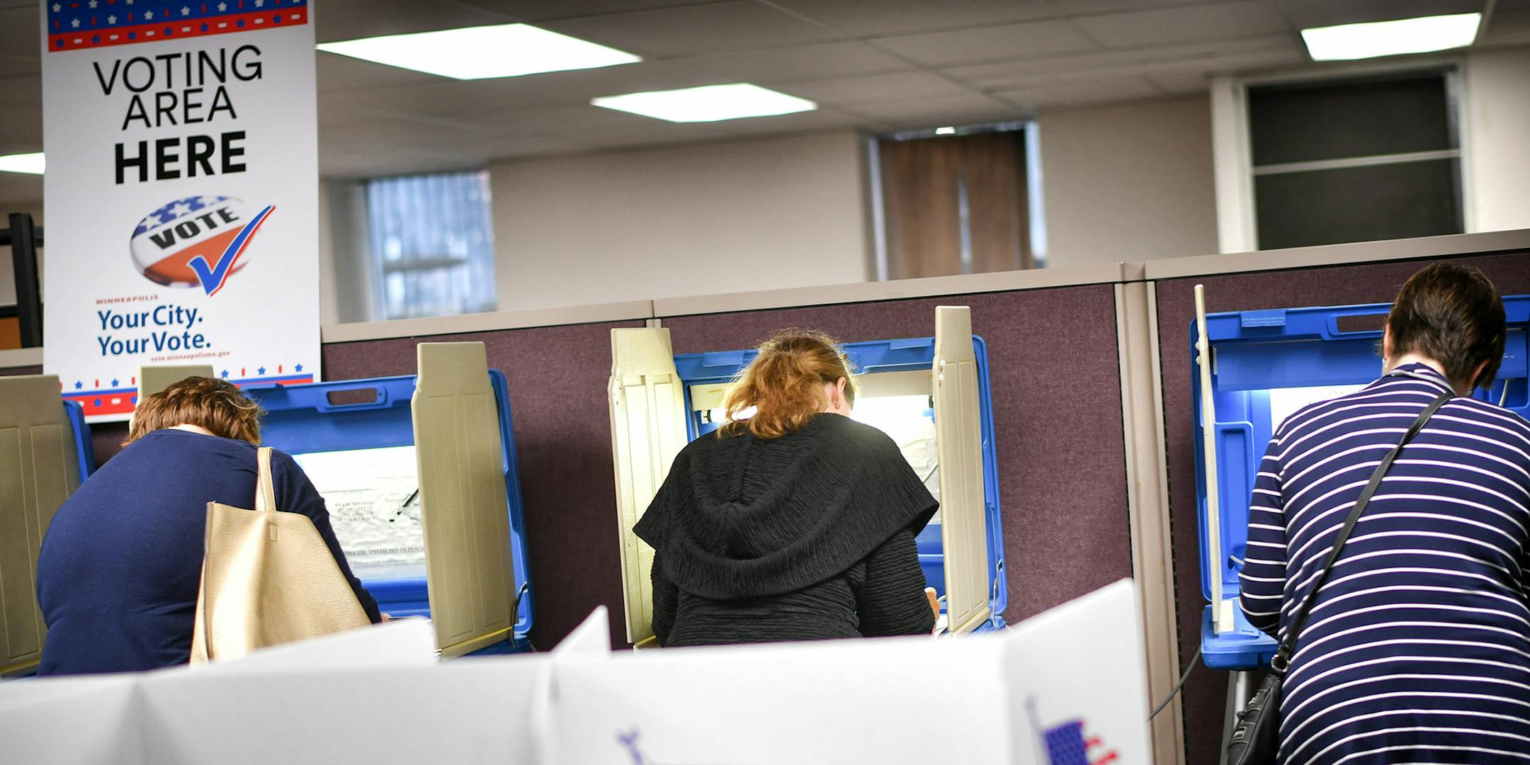 Voters cast their ballots at a voting center in Minneapolis Friday, Sept. 23, 2016. Friday kicked off the state's early voting period, making Minnesota among the first states to open up voting. It's the state's second election with early voting as an option but the first during a presidential contest. (Glen Stubbe/Star Tribune via AP) ORG XMIT: MIN2016093017575455