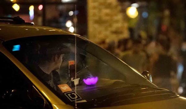 An Uber and Lyft driver waited to pick up passengers at Lagoon and Hennepin avenues in Minneapolis after bar closing time in August.