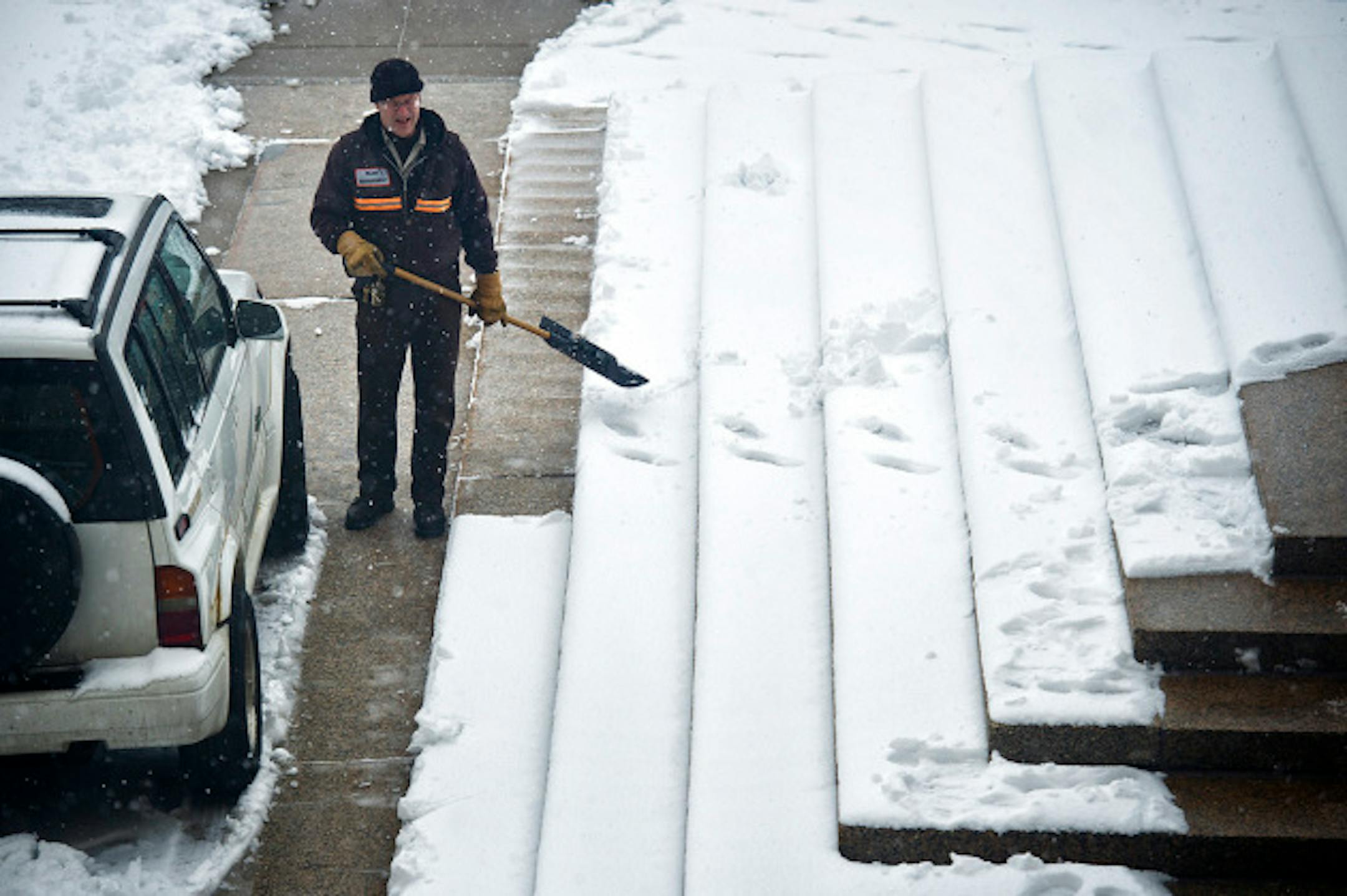 Shoveling heavy wet snow from the front Capitol steps Thursday, April 11, 2013, groundskeeper Jay Johnston said "No matter how many paths I shovel here people just seem to want to make their own".       ]   GLEN STUBBE * gstubbe@startribune.com