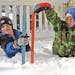 Two boys measured the snow depths near their home in north Bismarck, N.D., on Friday, Nov. 11, 2022. 