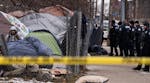 Police arrive ahead of the shutdown of a homeless encampment, dubbed Camp Nenookaasi, in Minneapolis in January.