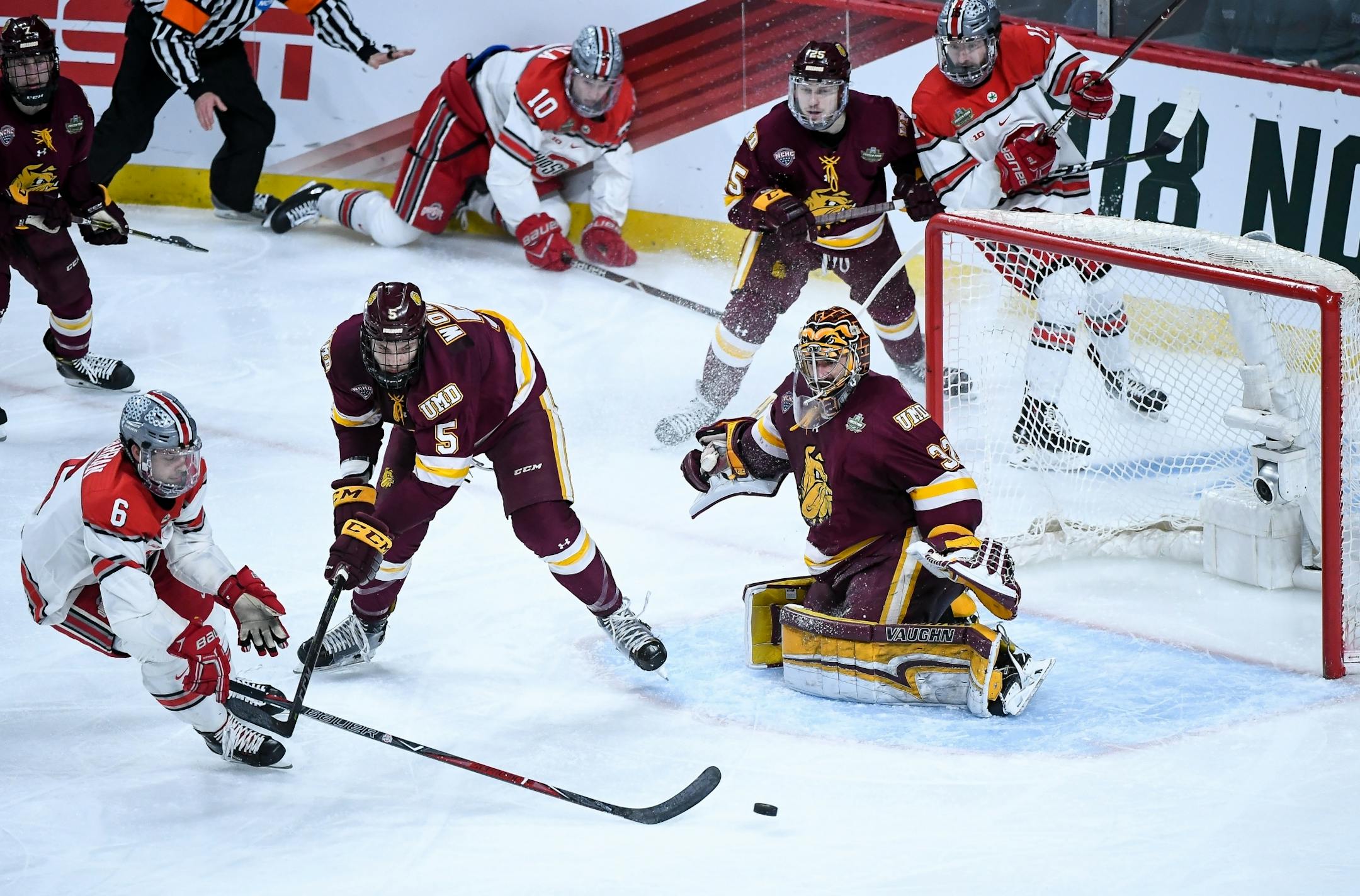 Minnesota Duluth goaltender Hunter Shepard eyed the puck as defenseman Nick Wolff and Ohio State defenseman Tommy Parran (6) battled in front of the net in the second period.