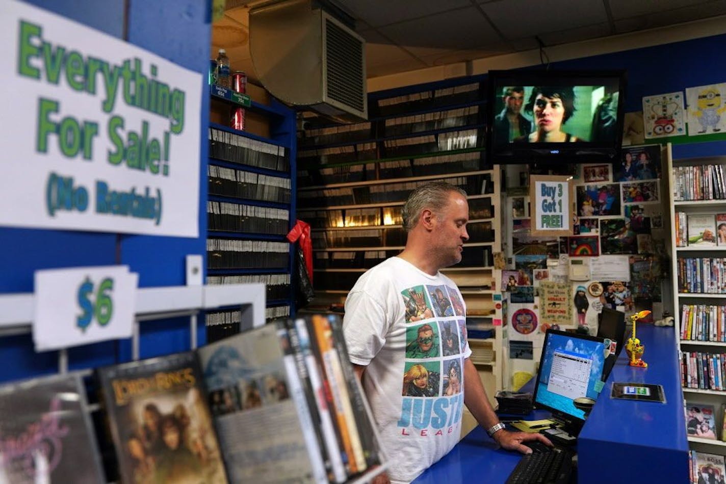 Owner Tim Hanson looked up a title in the computer at The Movies on 35th Street.