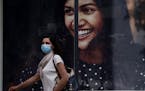 A woman wearing a mask walks along Ledra Street, a busy shopping thoroughfare in the medieval center of capital Nicosia, Cyprus, on Thursday, May 7, 2