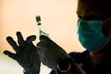 A health worker prepares a syringe with the Pfizer COVID-19 vaccine at a clinic in Reading, Pa., in 2021.
