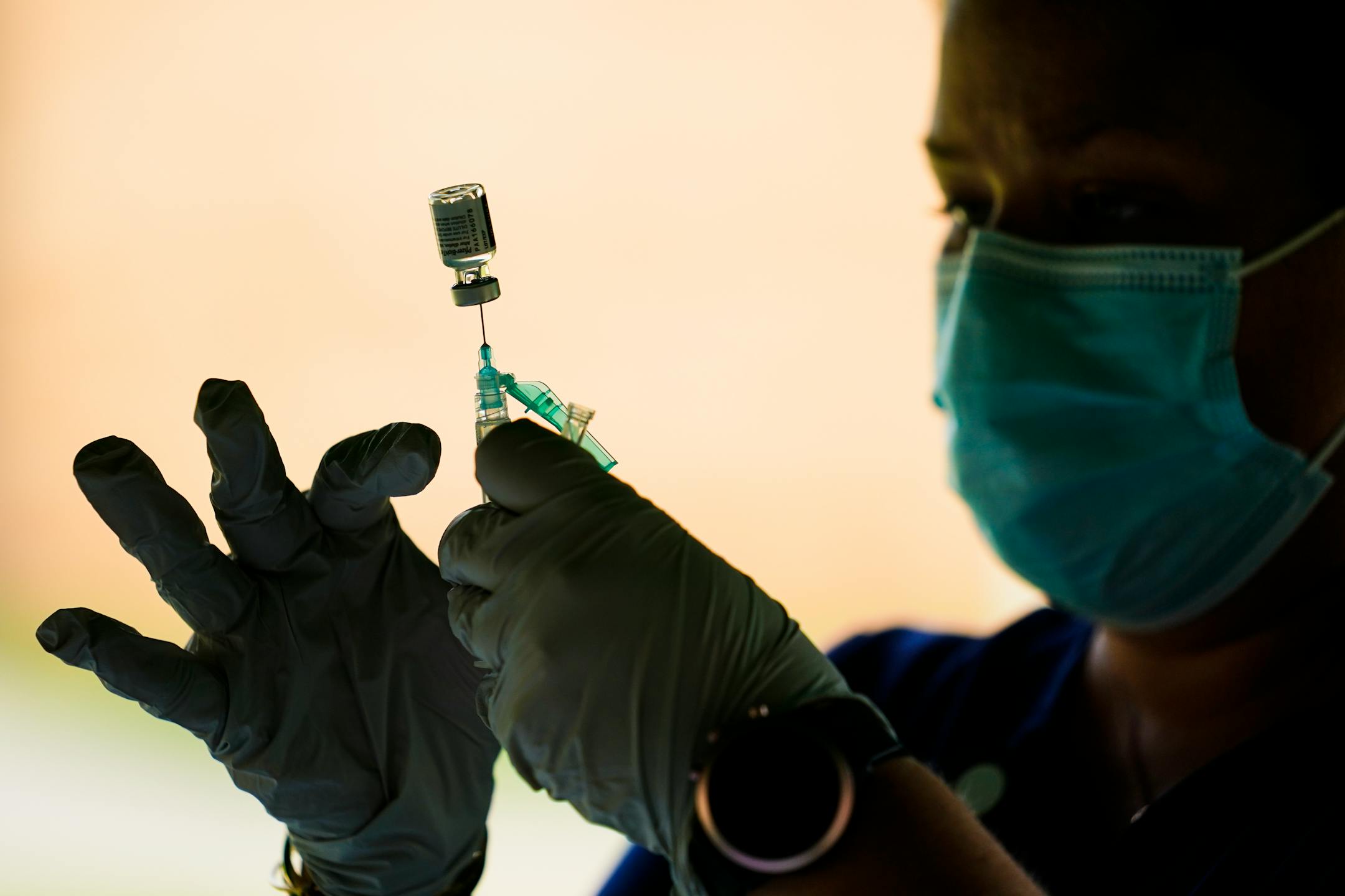 A health worker prepares a syringe with the Pfizer COVID-19 vaccine at a clinic in Reading, Pa., in 2021.