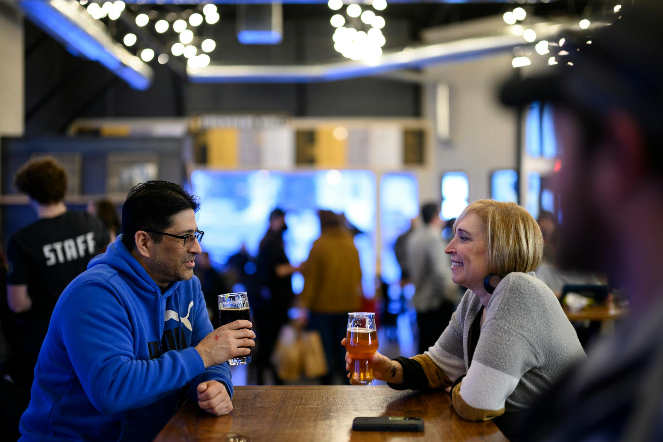 Rick Cruz and friend Becky Cahn, a founding club member, drank beer in the taproom Wednesday, Feb. 9, 2022 at Nine Mile Brewing in Bloomington, Minn.