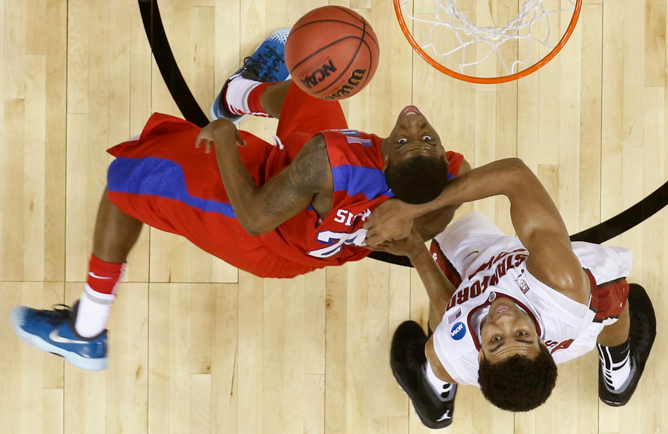 Dayton guard Jordan Sibert (24) shoots as Stanford forward Josh Huestis (24) looks on during the first half in a regional semifinal game at the NCAA college basketball tournament, Thursday, March 27, 2014, in Memphis, Tenn. (AP Photo/John Bazemore)