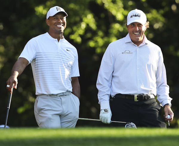 Tiger Woods, left, and Phil Mickelson.