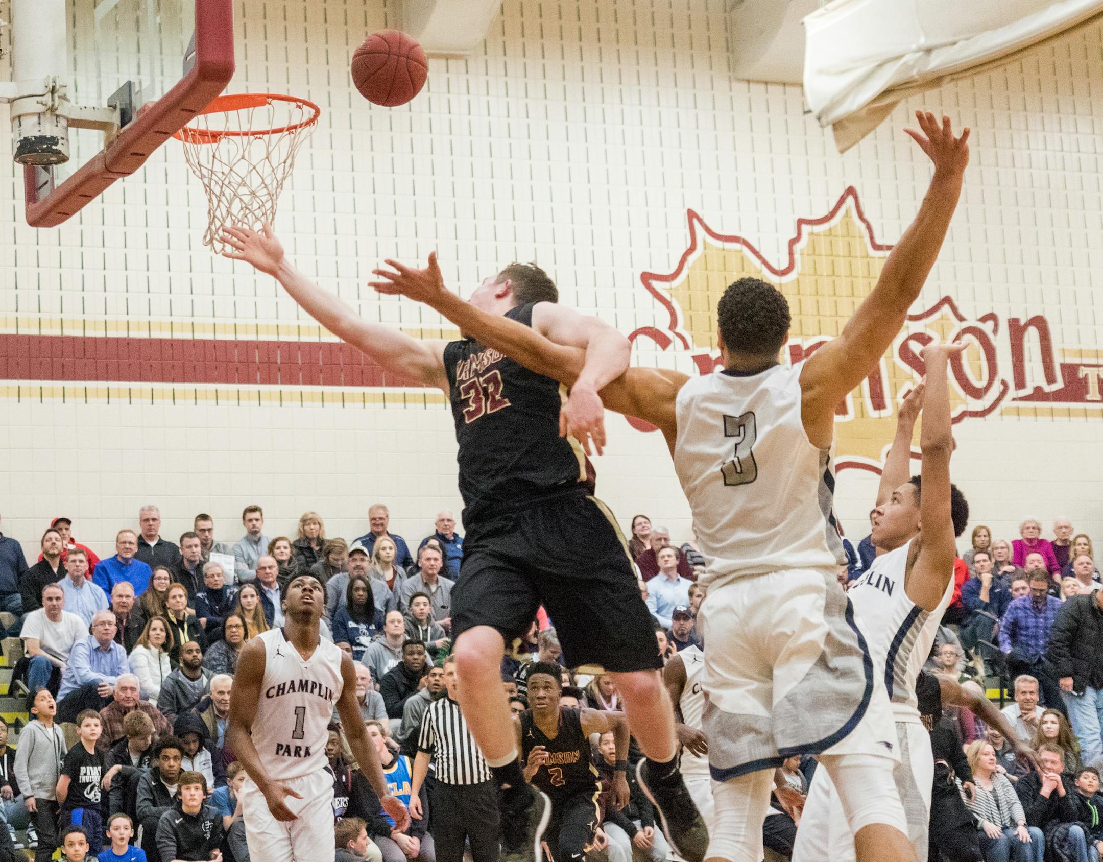 Champlin Park center Theo John blocked a layup attempt by Maple Grove’s Jack Hutchison (32) on Monday night. Champlin Park improved to 18-0.