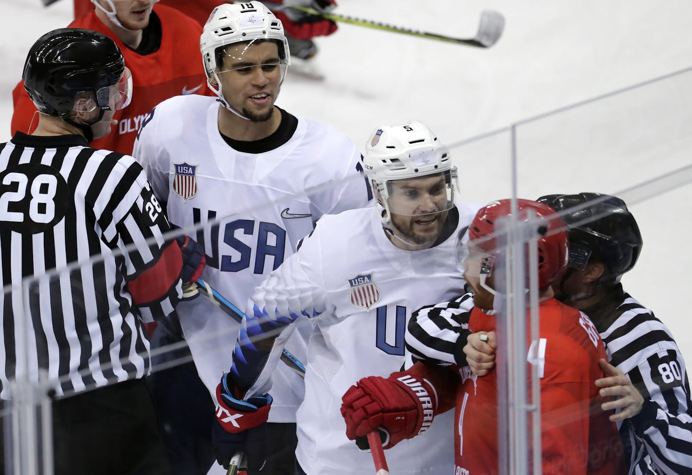 Referees break up a fight between Russian athlete Vladislav Gavrikov (4) and Noah Welch (5) and Jordan Greenway (18), of the United States during the third period of the preliminary round of the men's hockey game at the 2018 Winter Olympics in Gangneung, South Korea, Saturday, Feb. 17, 2018. (AP Photo/Julio Cortez)