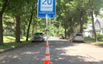 Residents along S. Garfield Avenue near W. 34th Street in Minneapolis attached a "20 is Plenty" sign to a pylon and placed it in the middle of the str