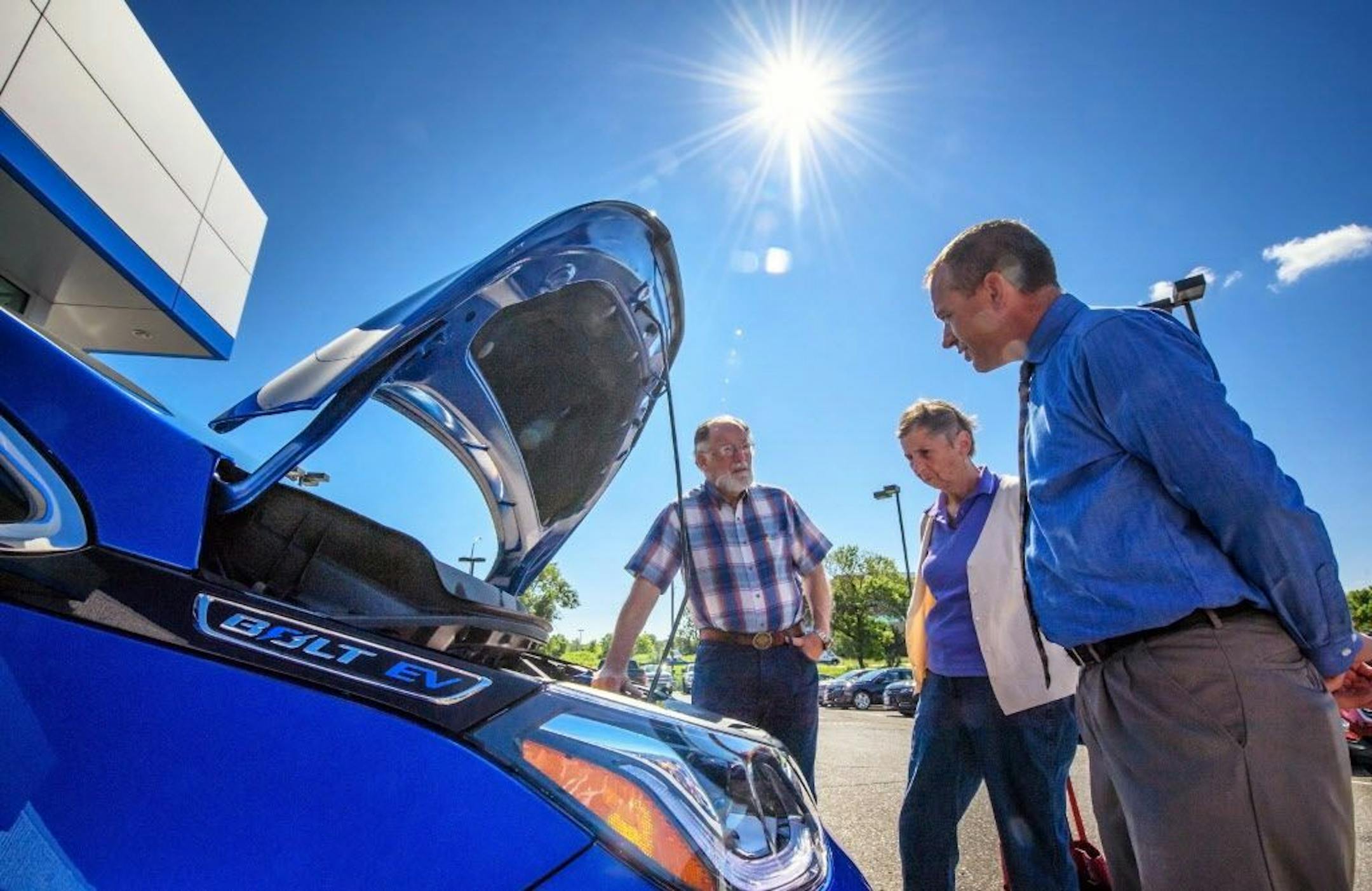 Rosedale Chevrolet salesman David Troy helped Van and Sue Gooch look over a Chevy Bolt electric vehicle at the dealership on July 7, 2017.