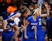Minnetonka players, including forward Courtney Fredrickson (24) and guard Hannah Hedstrom (4), left, celebrated an and-one opportunity by guard Grace 