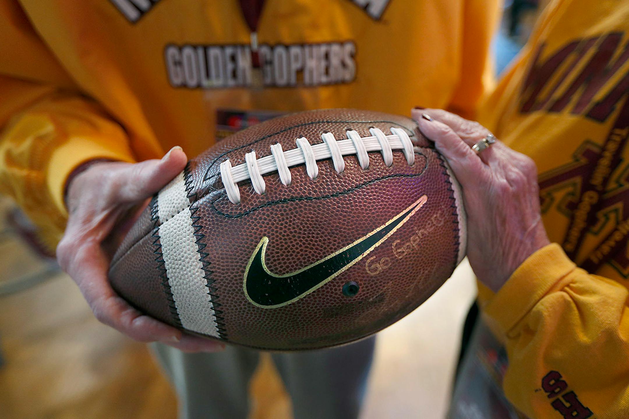 Minnesota head football coach Tracy Claeys made a surprise appearance as he presented first time bowl visitors Warren and Ardella Quarnstrom with a football during a breakfast, Tuesday, December 27, 2016 in San Diego, CA. The couple, both 91, made their first time football bowl trip from Marshall, MN.