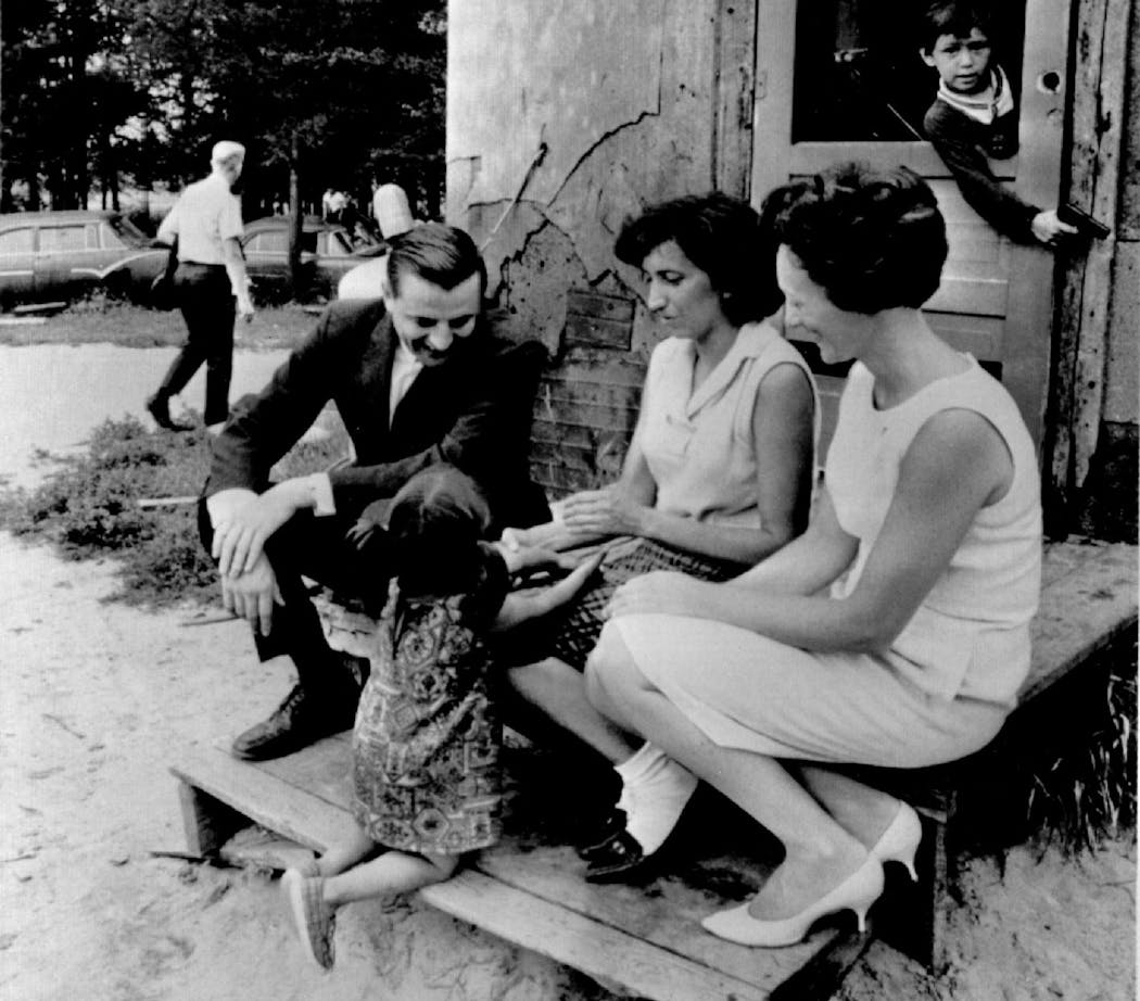 In this 1966 photo, Walter Mondale, then a U.S. senator from Minnesota, and his wife, Joan, visited with Mrs. Joseph Whitebird, center, and children at their home on the Leech Lake Indian Reservation. The Mondales took part in groundbreaking ceremonies for a 50-unit affordable housing project on the reservation.