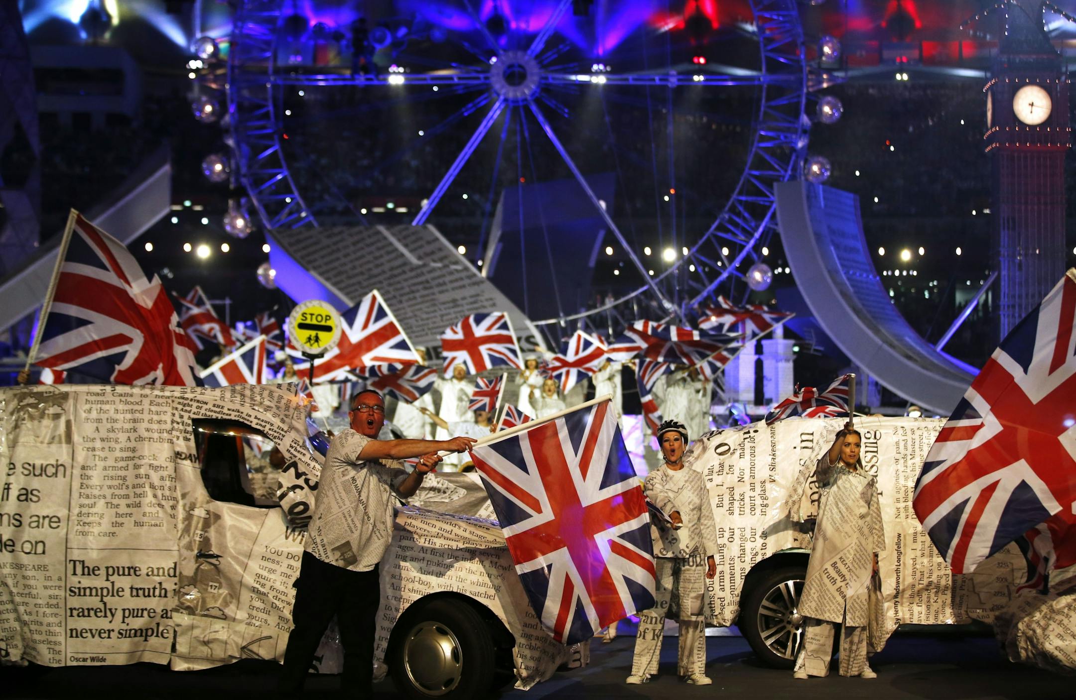 Performers wave British flags during the Closing Ceremony at the 2012 Summer Olympics, Sunday.
