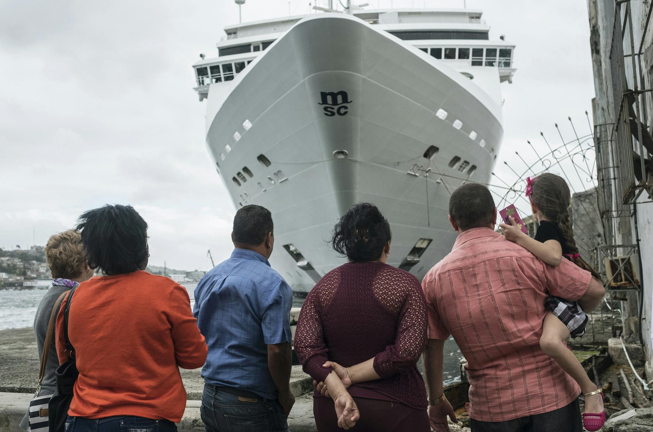 People stand in front of an MSC Cruises ship docked in Havana, Cuba, on Jan. 27, 2018. MUST CREDIT: Bloomberg photo by Francesco Pistilli.
