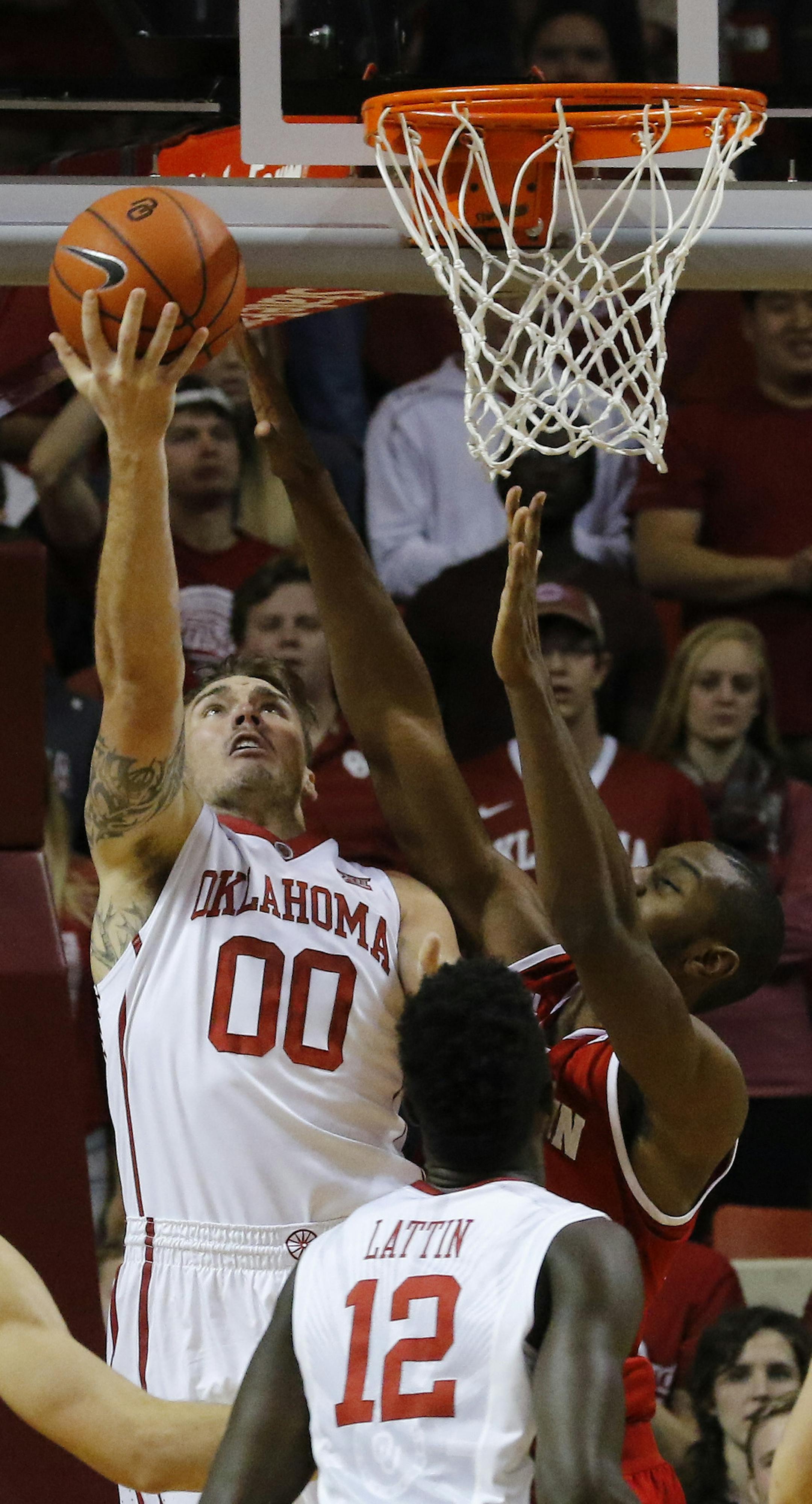 Oklahoma forward Ryan Spangler (00) goes to the basket against Wisconsin during the first half of an NCAA college basketball game in Norman, Okla., Sunday, Nov. 29, 2015. (AP Photo/Alonzo Adams)