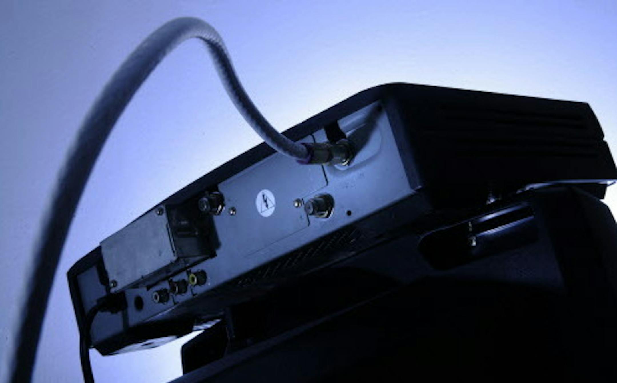 FILE - This Wednesday, May 30, 2007, file photo shows a cable box on top of a television in Philadelphia. Cable boxes may not be very exciting, but they&#xed;re emerging as a new battleground over the future of TV. Technology companies and the government want to open up the boxes to new services and programming. Cable companies want to keep control in their own hands. The outcome could affect what you pay for television and whether you&#xed;ll still need to clutter your entertainment center with