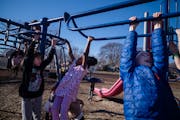 Kindergarteners and first-graders enjoy the unseasonably warm weather on the playground at the Windom Community School in Minneapolis on Jan. 31.