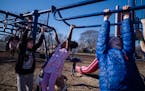 Kindergarteners and first-graders enjoy the unseasonably warm weather on the playground at the Windom Community School in Minneapolis on Jan. 31.