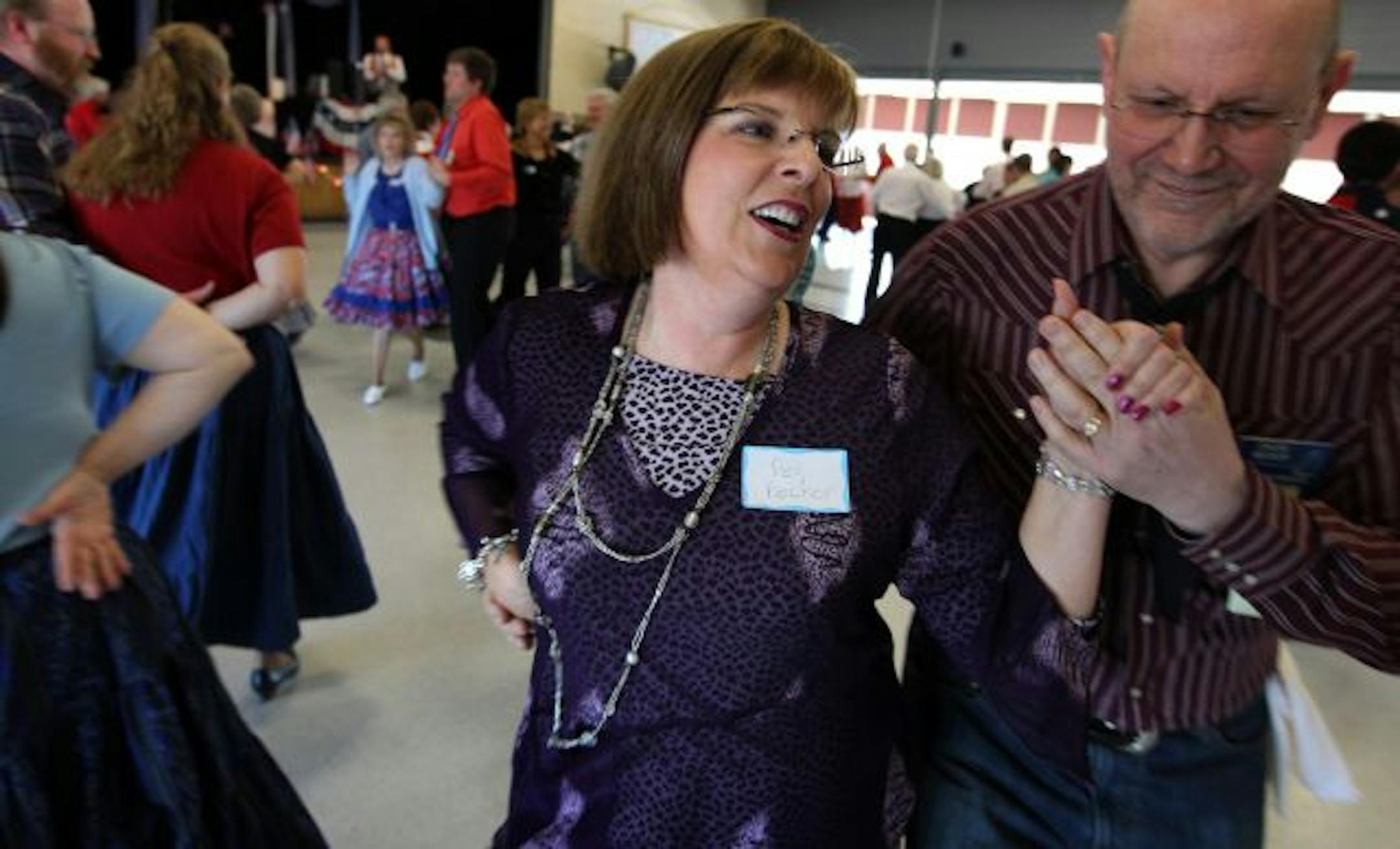 Square-dancing class graduates Peggy and Chuck Becker show off their new moves with the Westonka Whirlers at the Grandview Middle School in Mound.