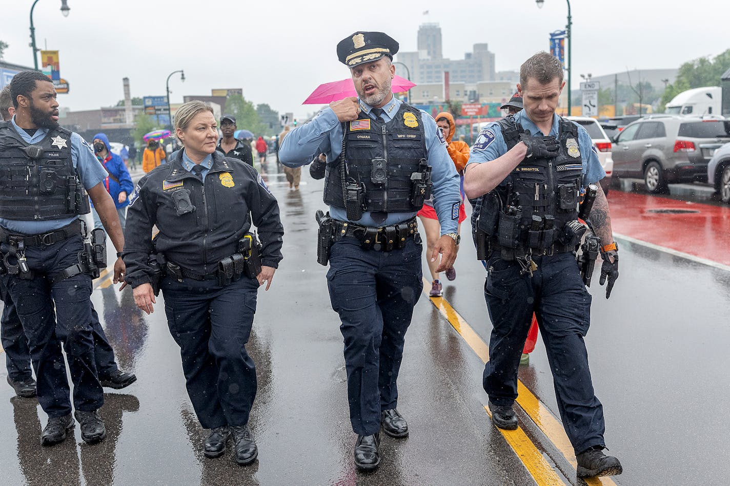 Minneapolis Police Chief Brian O’Hara, second from right, makes his way down W. Lake Street amid protests over a federal raid in south Minneapolis on June 3.