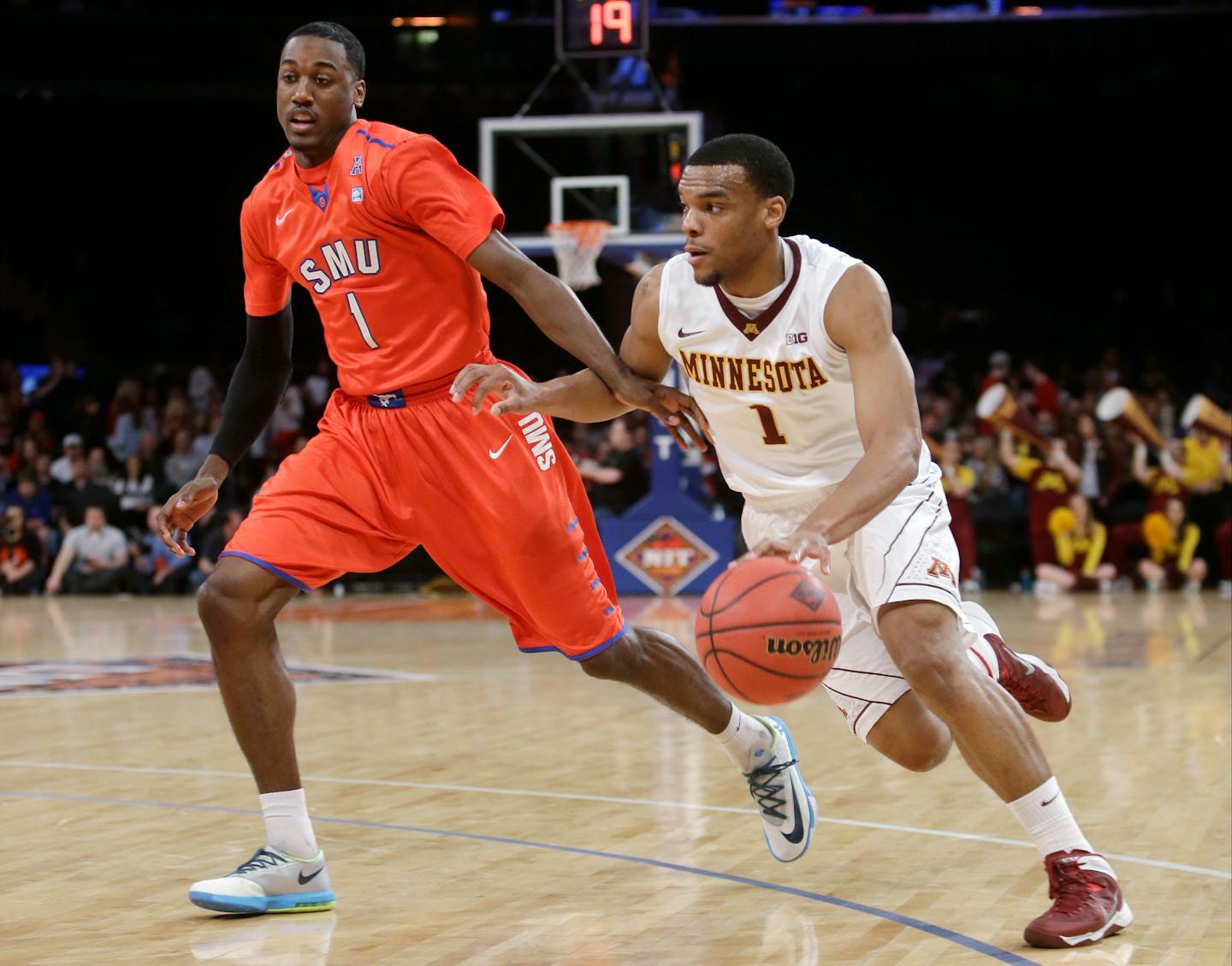 Minnesota's Andre Hollins (1) drives past SMU's Ryan Manuel (1) during the first half of an NCAA college basketball game in the final of the NIT, Thursday, April 3, 2014, in New York. (AP Photo/Frank Franklin II)