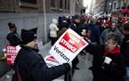 Verizon workers picket in front of a company facility, Wednesday, April 13, 2016, in New York. Tens of thousands of Verizon landline and cable workers