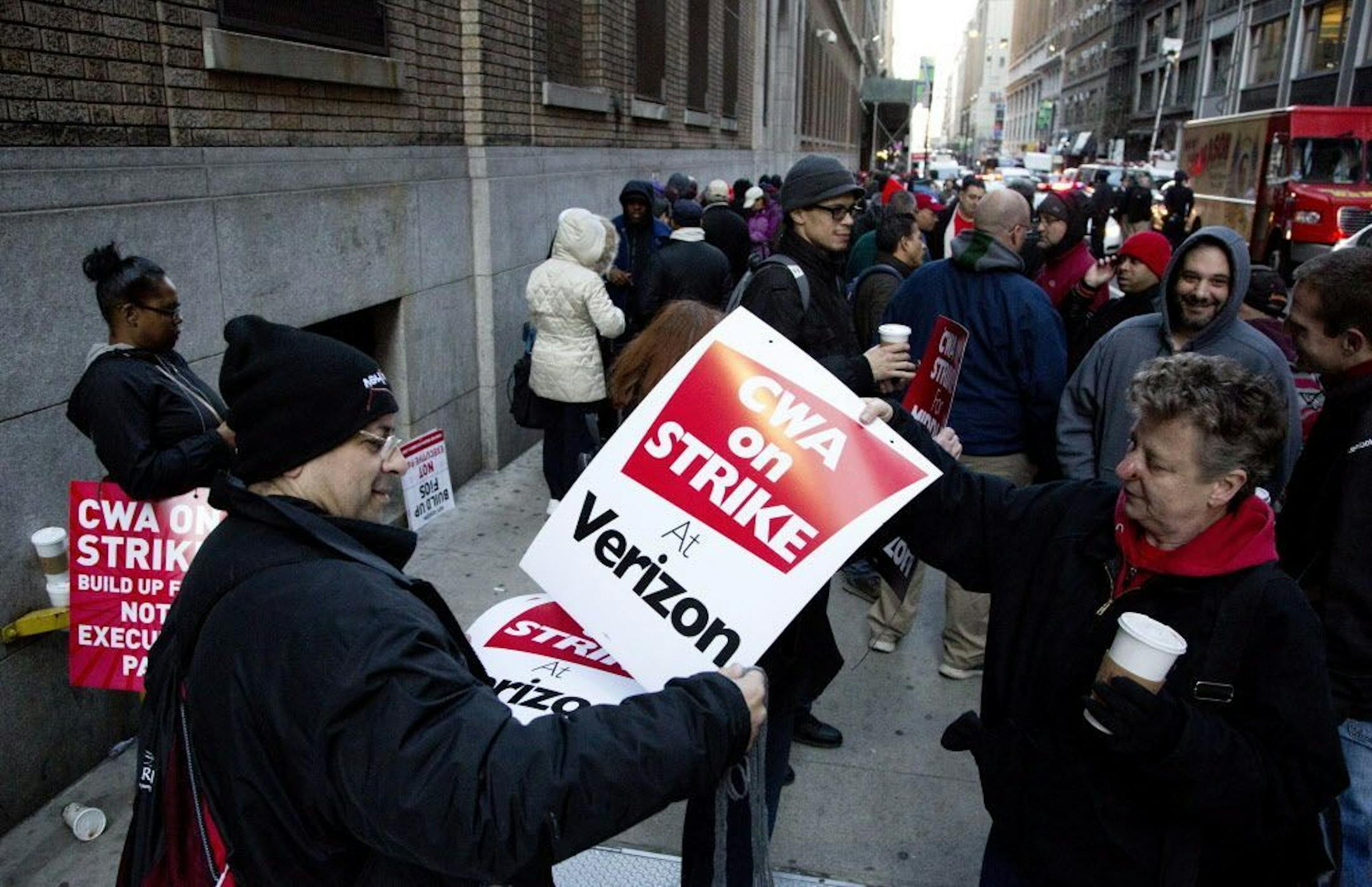 Verizon workers picket in front of a company facility, Wednesday, April 13, 2016, in New York. Tens of thousands of Verizon landline and cable workers on the East Coast walked off the job Wednesday morning after little progress in negotiations since their contract expired nearly eight months ago.