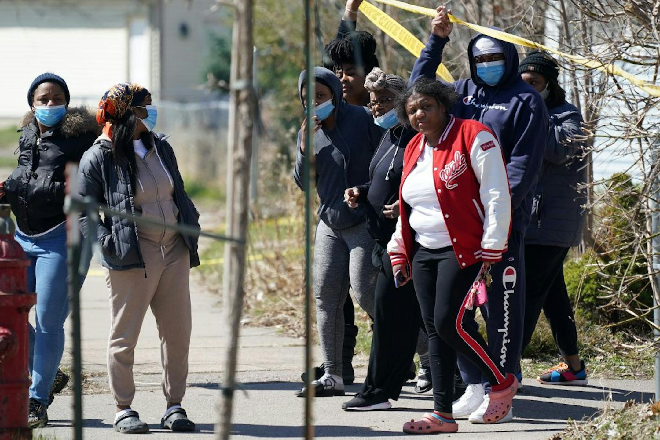 Bystanders crossed police tape to get a better look after a man arrived screaming at the scene of a homicide Saturday in the 1100 block of Irving Avenue North.