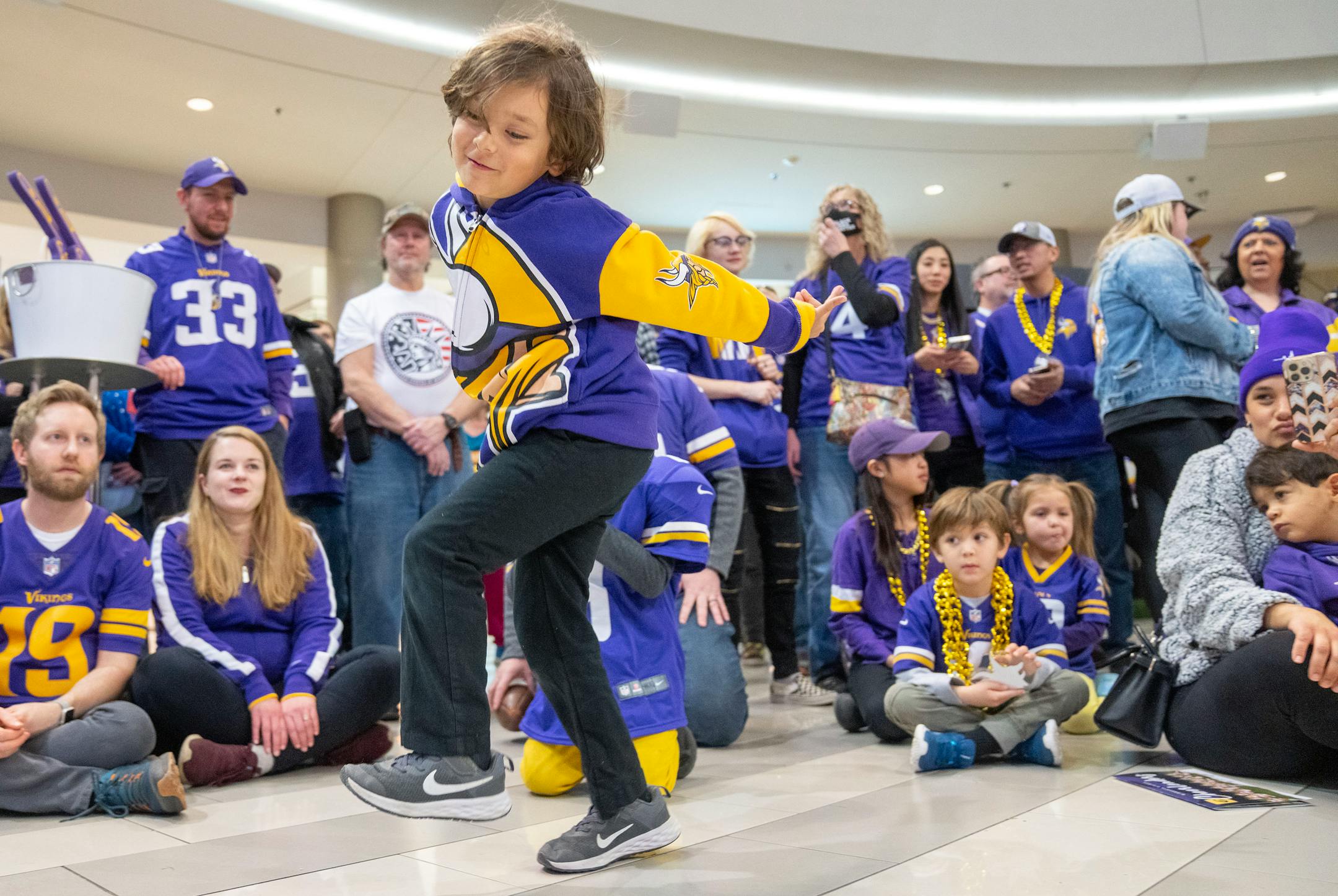 Leonardo Milan does the gritty in front of other fans during a Vikings fan rally.
