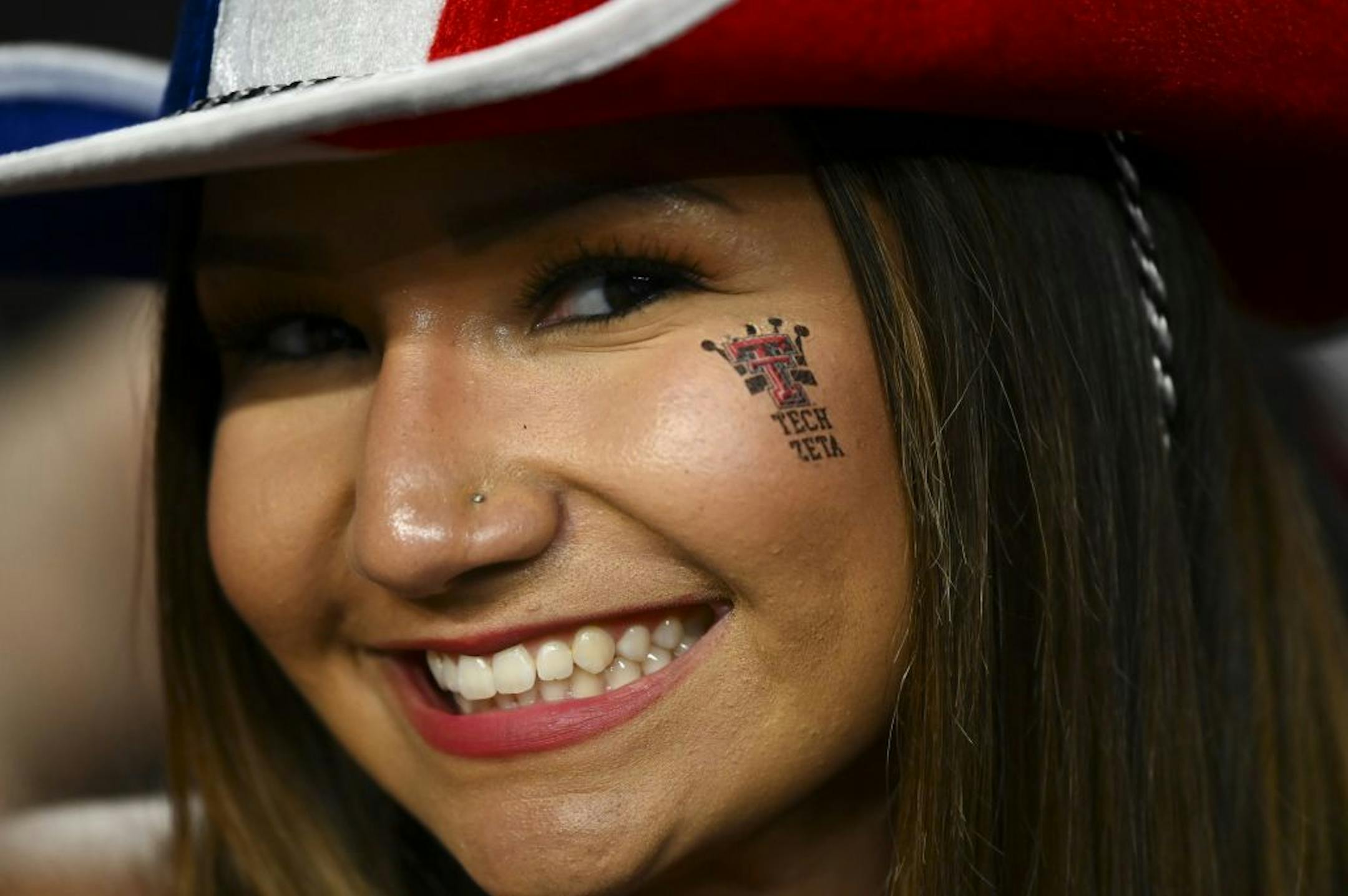 Natalie Elizondo, a Texas Tech freshman studying pre-med, showed of her "Tech Zeta" temporary tattoo while waiting for Monday night's game to start.