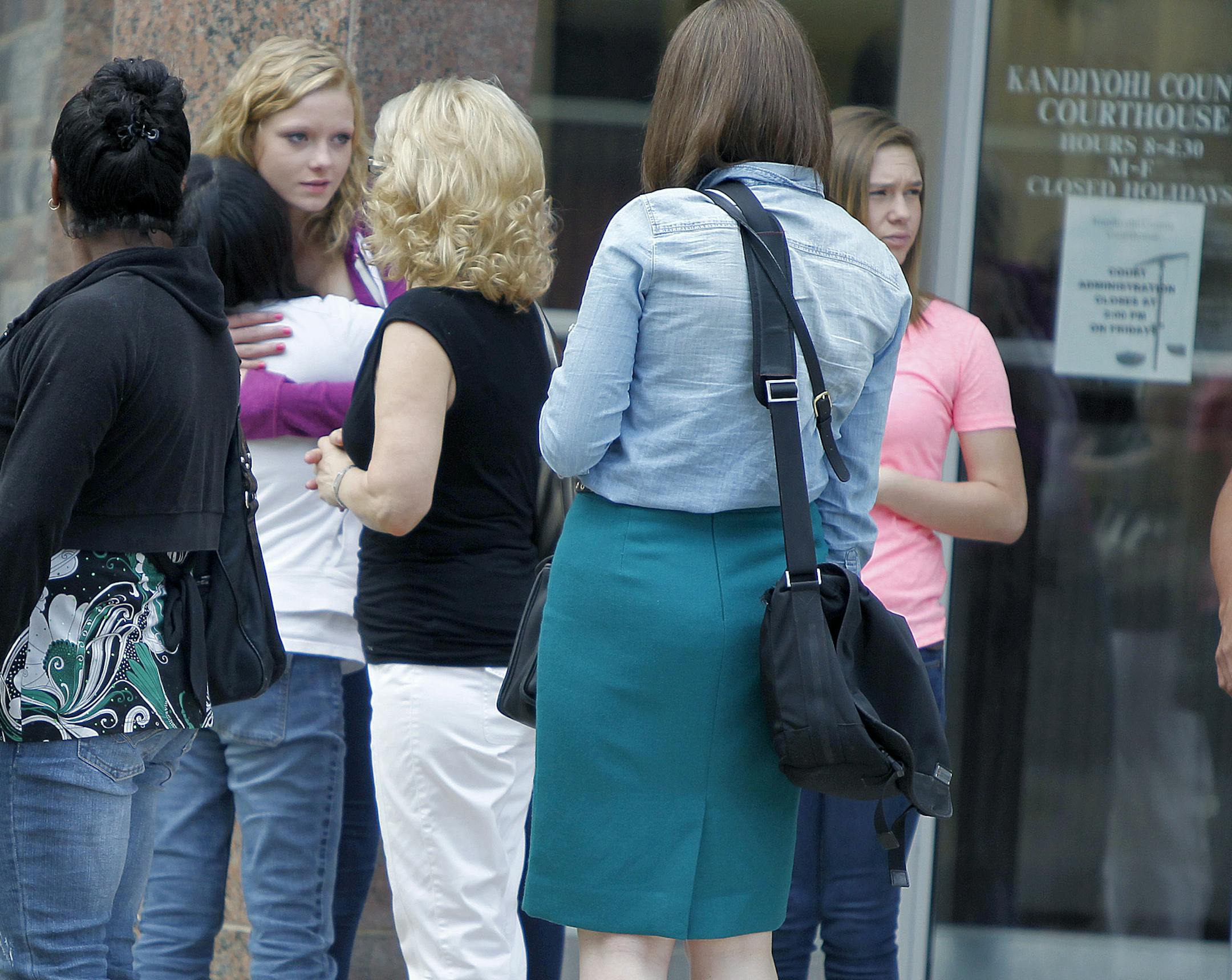 Friends and family members hugged each other after the court appearance of Robert Warwick, 17, at the Kandiyohi County Courthouse, Thursday, August 15, 2013 in Willmar, MN. Warwick is being charged in the death of his grandmother Lila Warwick. (ELIZABETH FLORES/STAR TRIBUNE) ELIZABETH FLORES • eflores@startribune.com