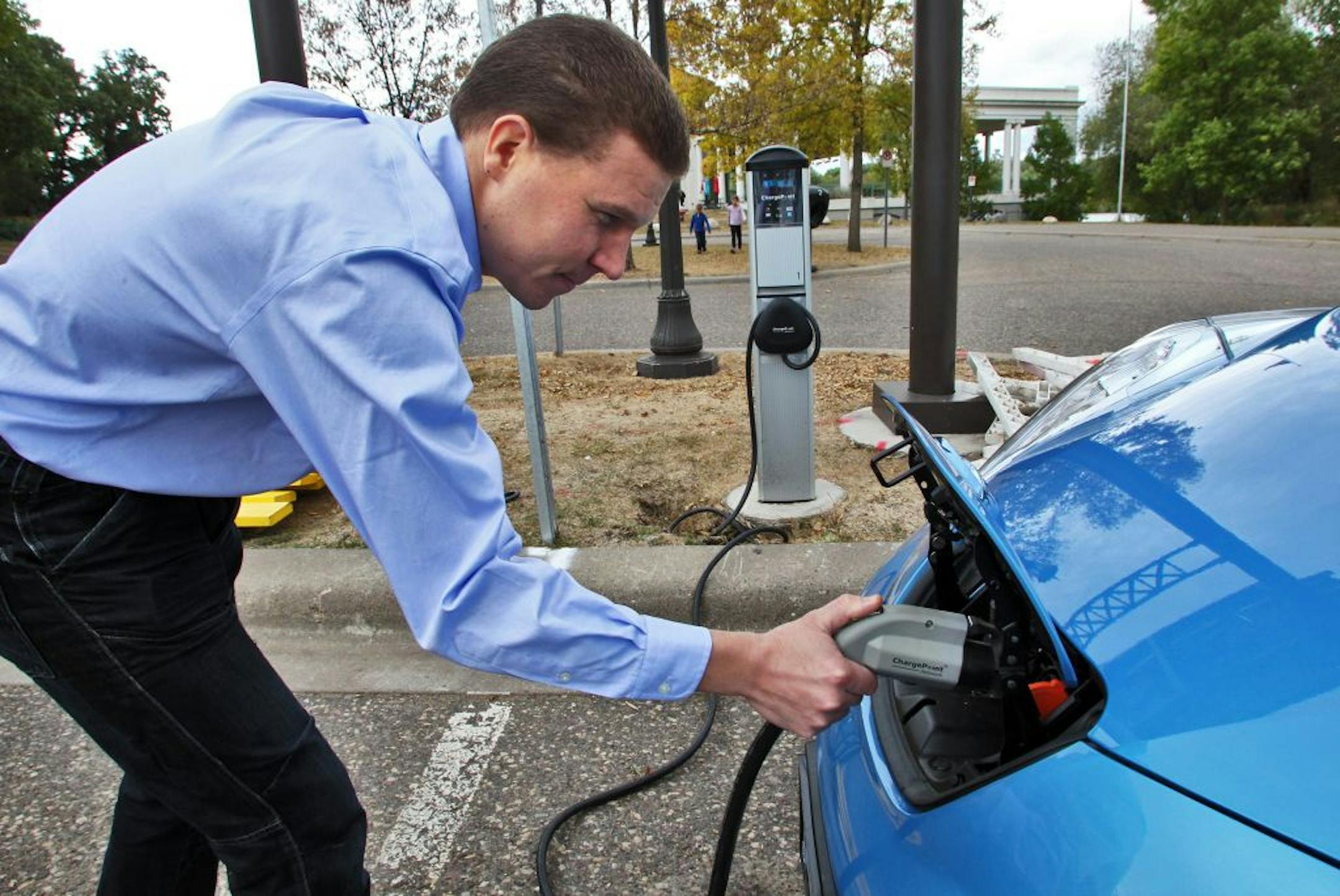 Jukka Kukkonen, of St. Paul, charged his Nissan Leaf all-electric car at a chargining station at the Pavillion parking lot at St. Paul's Como Park. Kukkonen has organized a meet-and-greet for electric car owners at Como Park this Sunday from 1pm to 4 pm. (MARLIN LEVISON/STARTRIBUNE(mlevison@startribune.com